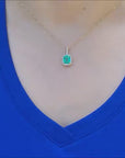 Natural colombian emerald pendant necklace with a halo diamond