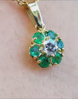Natural colombian emerald and diamond cluster pendant necklace in 18k yellow gold.