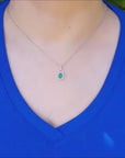 Natural colombian emerald and diamond pendant necklace made of 14k white gold.