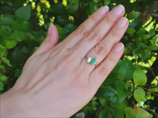 Natural marquise emerald and diamond you and me ring made of 18k yellow gold.