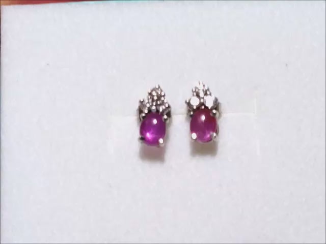 Natural star pink sapphire stud earrings crafted in 14k white gold.