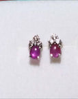 Natural star pink sapphire stud earrings crafted in 14k white gold.