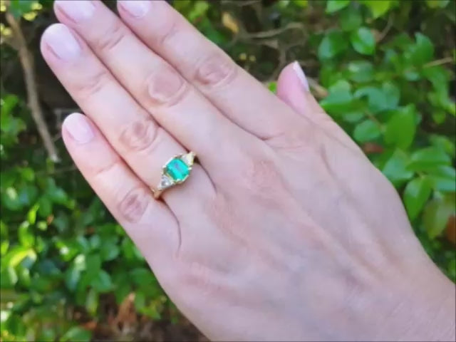 Natural colombian emerald three stone ring with side trillion cut diamonds 18k gold.