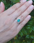 Pear shape halo emerald ring
