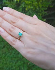 Gold ring with emerald and side baguette diamonds.