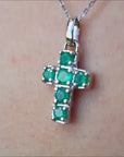 Natural colombian emerald cross pendant necklace crafted in 14k white gold.