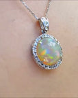 Welo Ethiopian opal pendant with a halo diamond in 14k white gold.