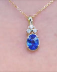 Natural tanzanite and diamond gold pendant for women.