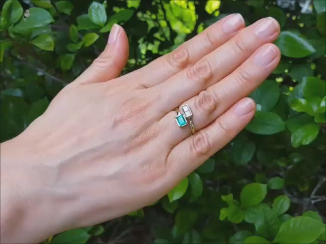 A 18k yellow gold you and me emerald diamond ring for women.