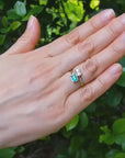 A 18k yellow gold you and me emerald diamond ring for women.