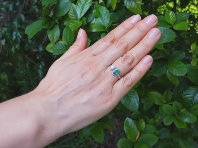 Negative space toi et moi emerald and diamond ring crafted in 18k white gold.