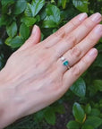 Negative space toi et moi emerald and diamond ring crafted in 18k white gold.
