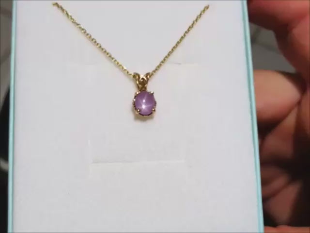 Natural star pink sapphire pendant necklace for ladies made of 14k gold.