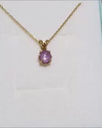 Natural star pink sapphire pendant necklace for ladies made of 14k gold.