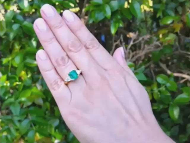 GIA certified natural colombian emerald ring with side trillion cut diamonds in 18k yellow gold.