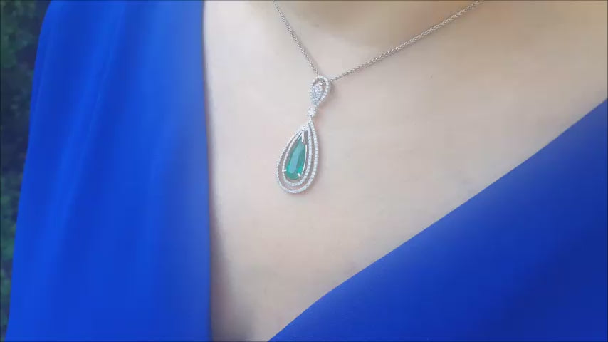 Teardrop colombian emerald and halo diamond pendant white gold.