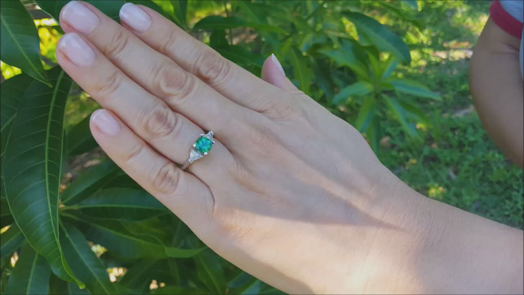 Round cut emerald and trillion side diamond ring
