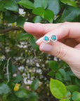 Emerald halo stud earrings