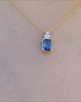 Natural blue sapphire pendant necklace crafted in 14 yellow gold.