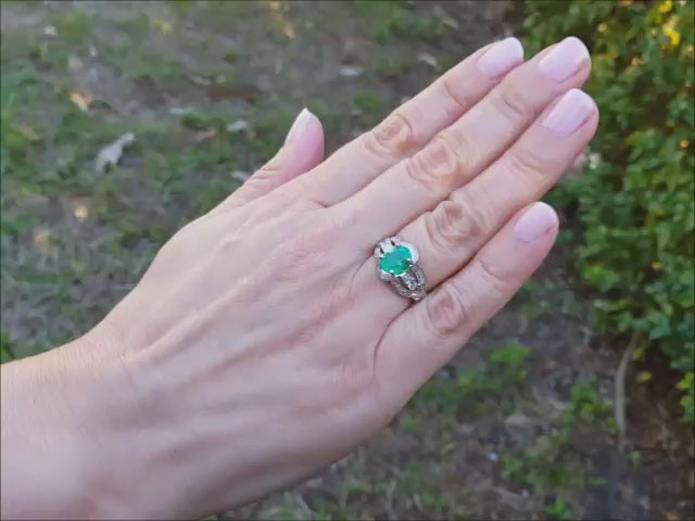 Natural colombian emerald ring oval cut with accent diamonds in 18k white gold.