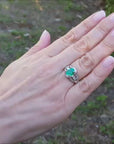 Natural colombian emerald ring oval cut with accent diamonds in 18k white gold.