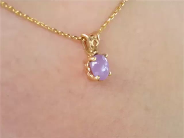 Natural cabochon pink sapphire pendant necklace made of 14k yellow gold.
