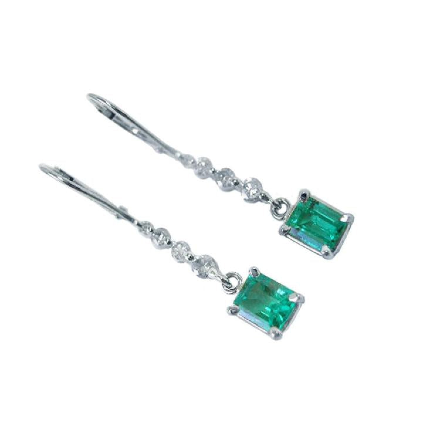 14K white gold dangle earrings with rectangular Colombian emeralds and clear accent stones.