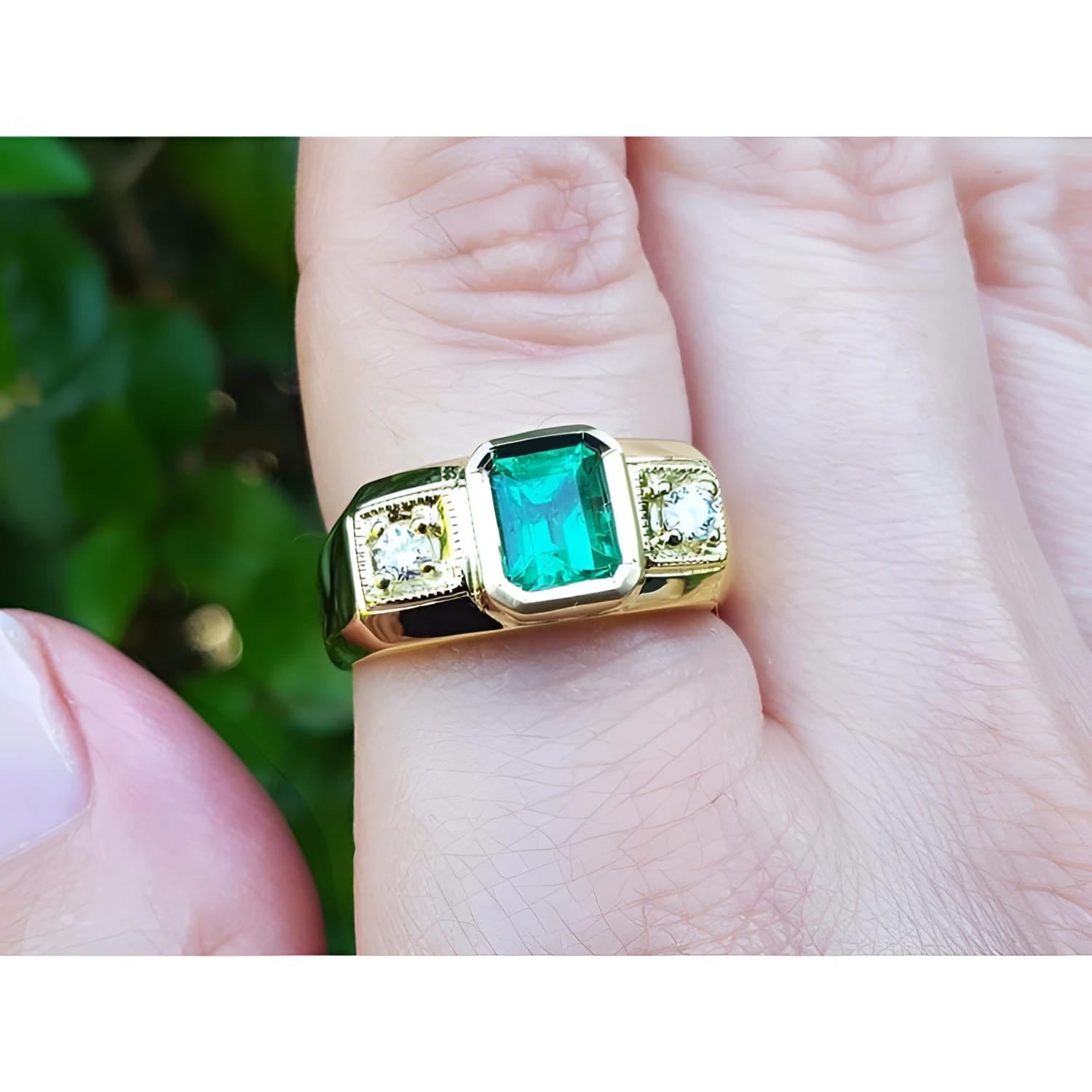 Men's 18K yellow gold ring with a rectangular emerald and two accent diamonds.