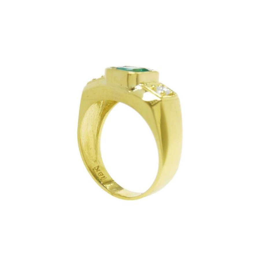 Men's 18K yellow gold ring with a bezel-set emerald and two accent diamonds.