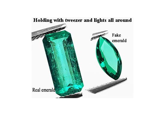 Real Versus man-made emeralds: This photo of two emeralds seen from the top with full lights around them shows the difference in their natural or fake texture.