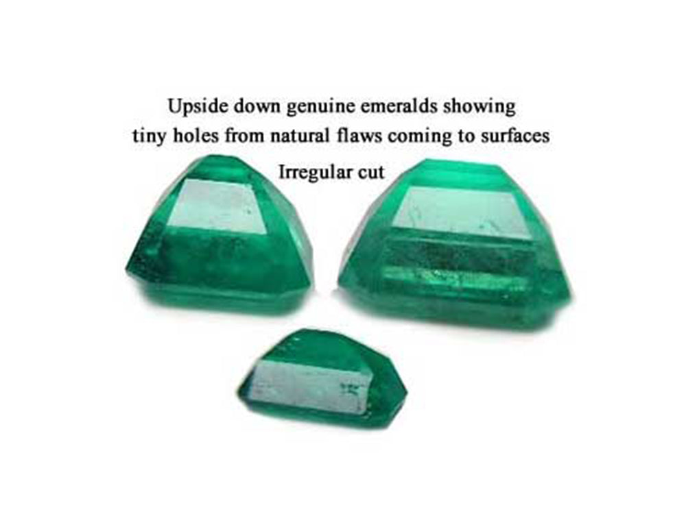 Irregular cut and surface reaching pores in the pavilion of natural emeralds is normal to preserve color, three stones upside down with tags.