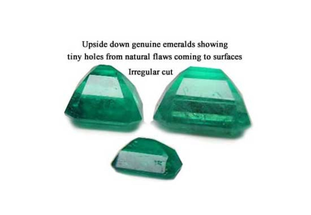 Irregular cut and surface reaching pores in the pavilion of natural emeralds is normal to preserve color, three stones upside down with tags.