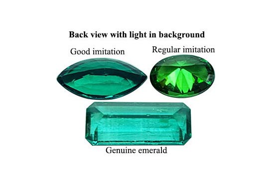 Real emeralds and man-made emeralds:  This photo of three upside-down stones shows more clearly the difference in their natural or fake texture.