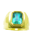 Topside view of a yellow gold emerald ring for men with bezel setting.
