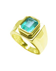 Gold ring with a genuine colombian emerald bezel set displaying top and lateral side visibles.