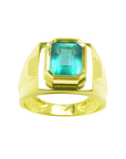 Gold ring with a natural colombian emerald bezel set topside view.