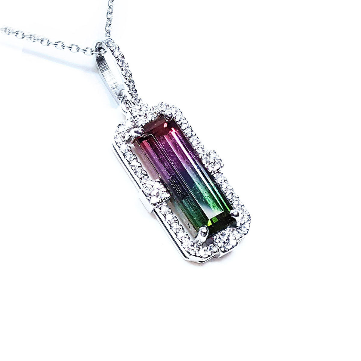 A natural brazilian watermelon tourmaline pendant with white gold and diamonds frame on white background