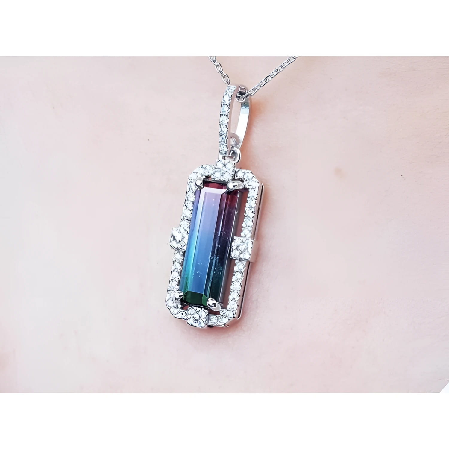 3.50 ct. watermelon tourmaline pendant with diamond halo on an 18K white gold chain.