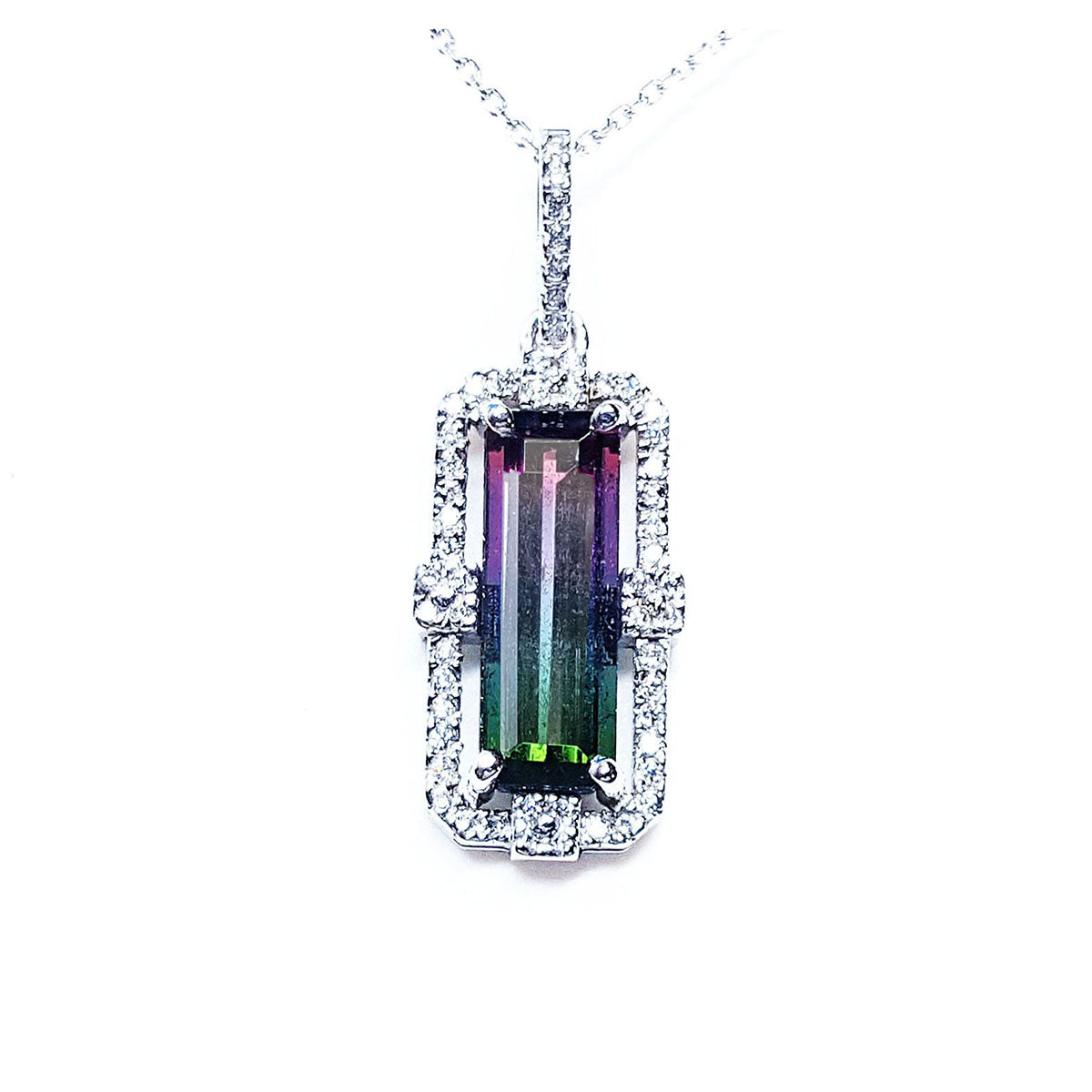 A brazilian watermelon tourmaline gemstone pendant with diamond accents on a topside view position.