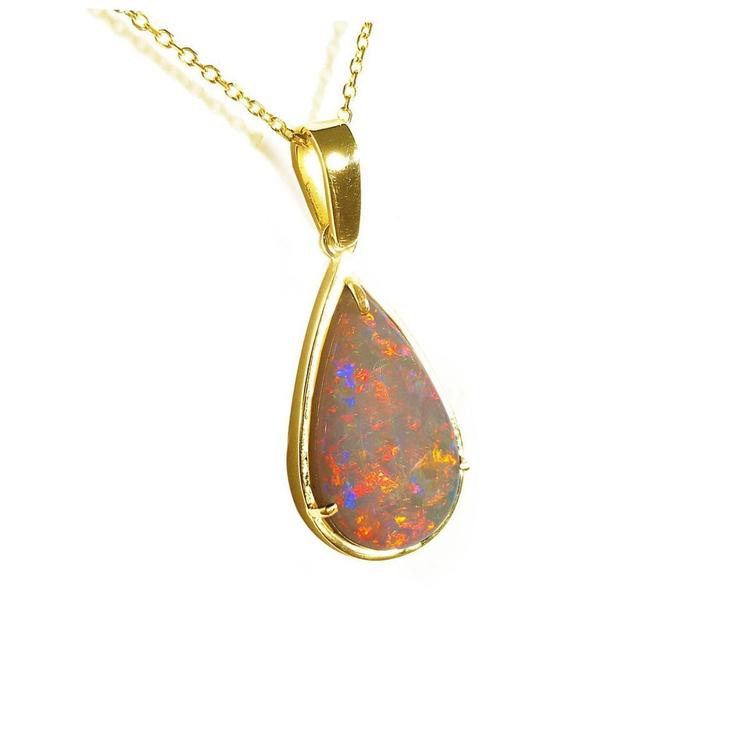 Gold pendant with a teardrop-shaped natural Australian opal stone on a right-side position, top and frame are visibles.