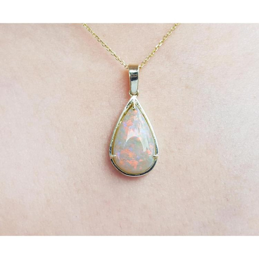 Pear-shaped Australian opal pendant with fiery red-orange hues in 14k yellow gold.