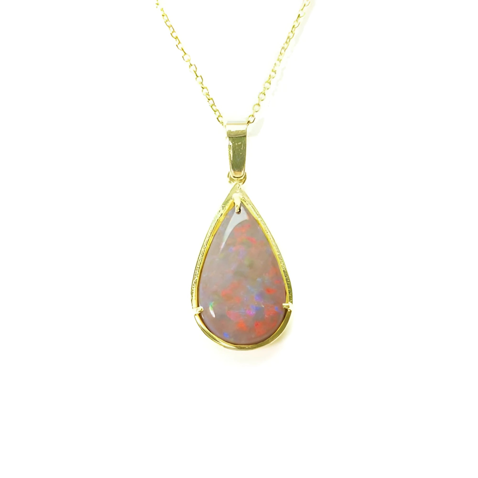 Pear-shaped Australian opal pendant with red/orange fire, set in 14k yellow gold on a delicate chain.