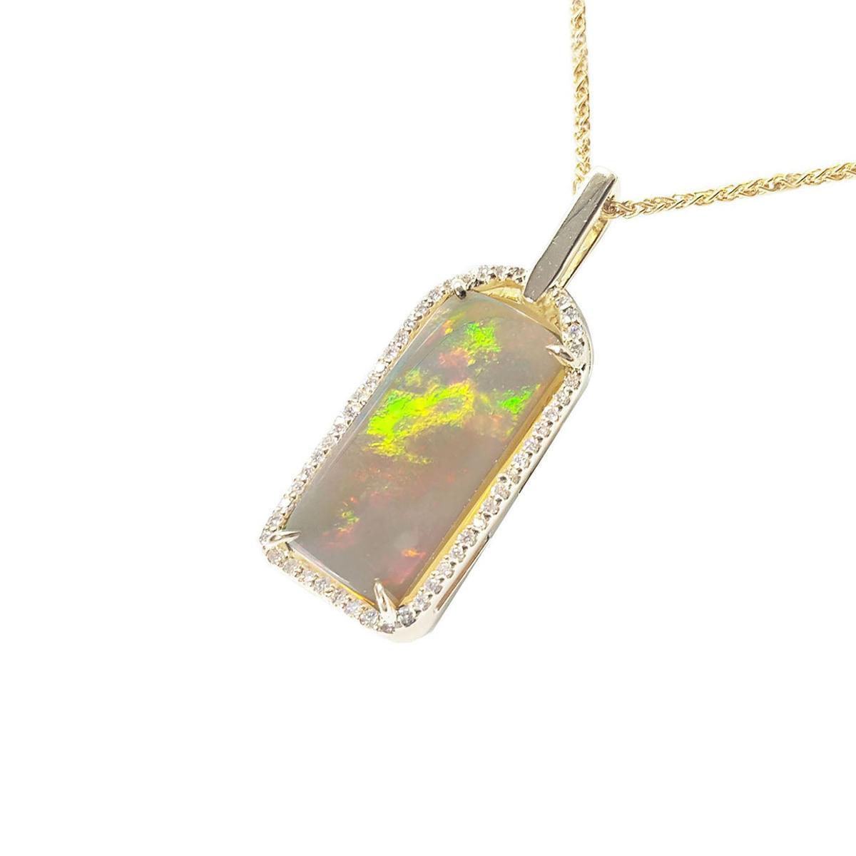 Opal pendant with gold and diamonds frame on a left-side position.