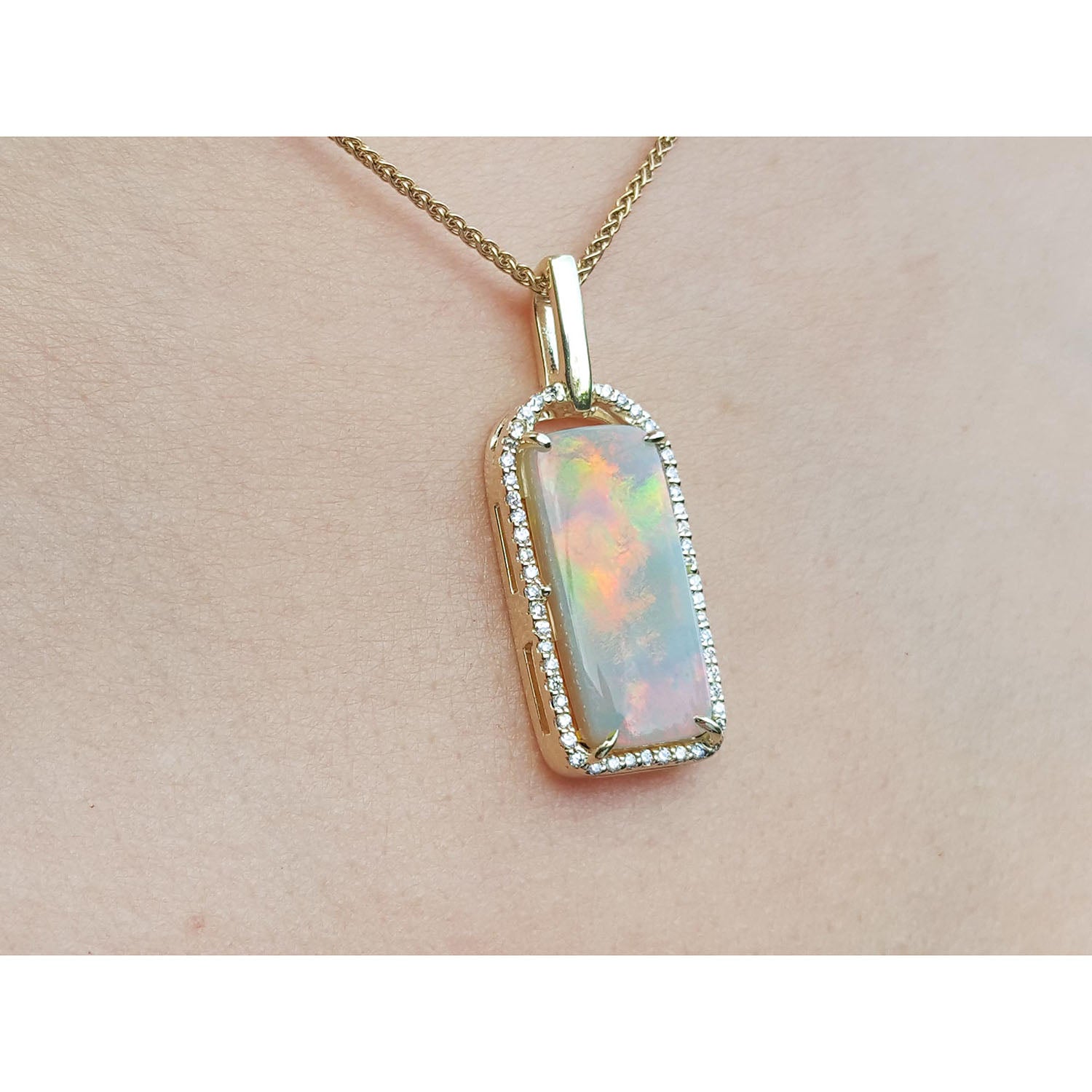 Opal pendant necklace on a person&#39;s chest.