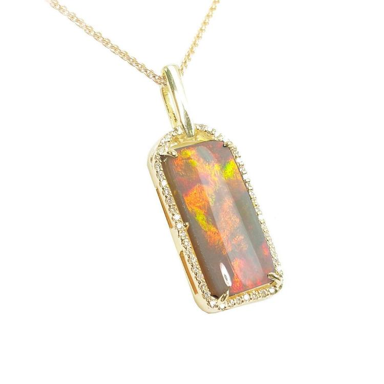 A natural Australian opal pendant necklace with gold chain on a right-side profile view.