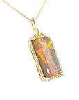 A natural Australian opal pendant necklace with gold chain on a right-side profile view.