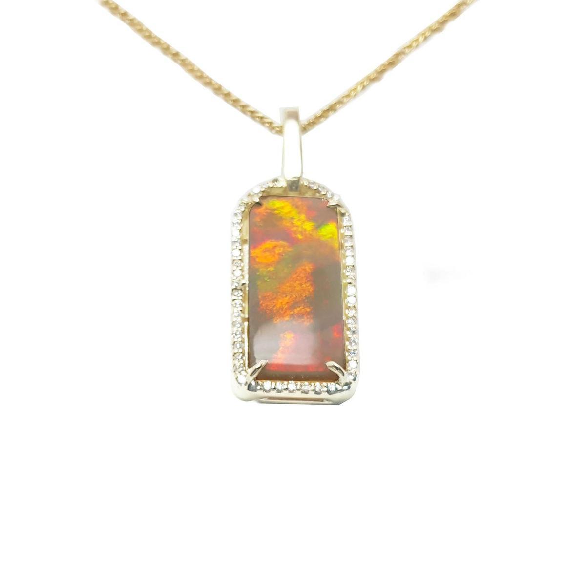 A red-orange fire natural Australian opal pendant necklace on a gold chain displaying its topside profile.