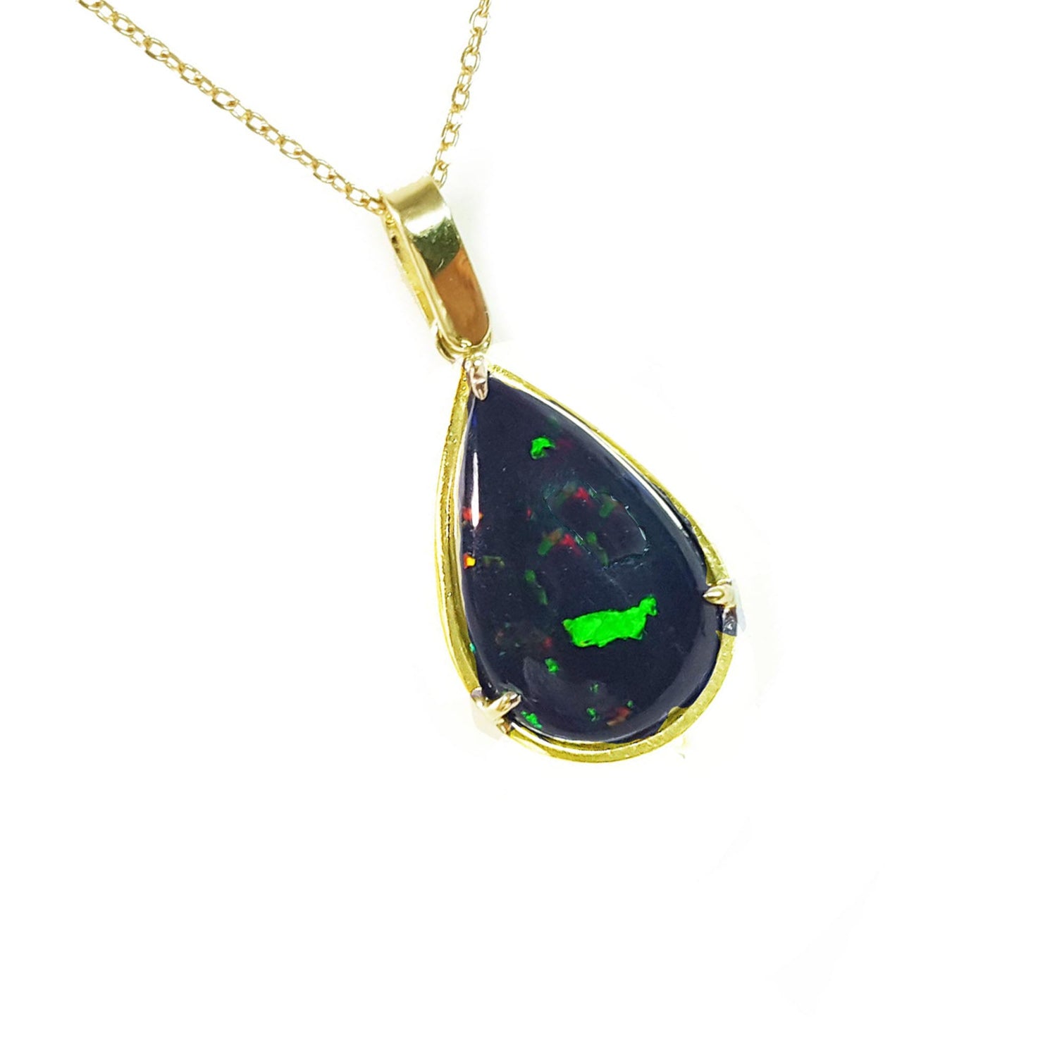 Teardrop-shaped Ethiopian black opal pendant with gold setting on a right-side profile view.
