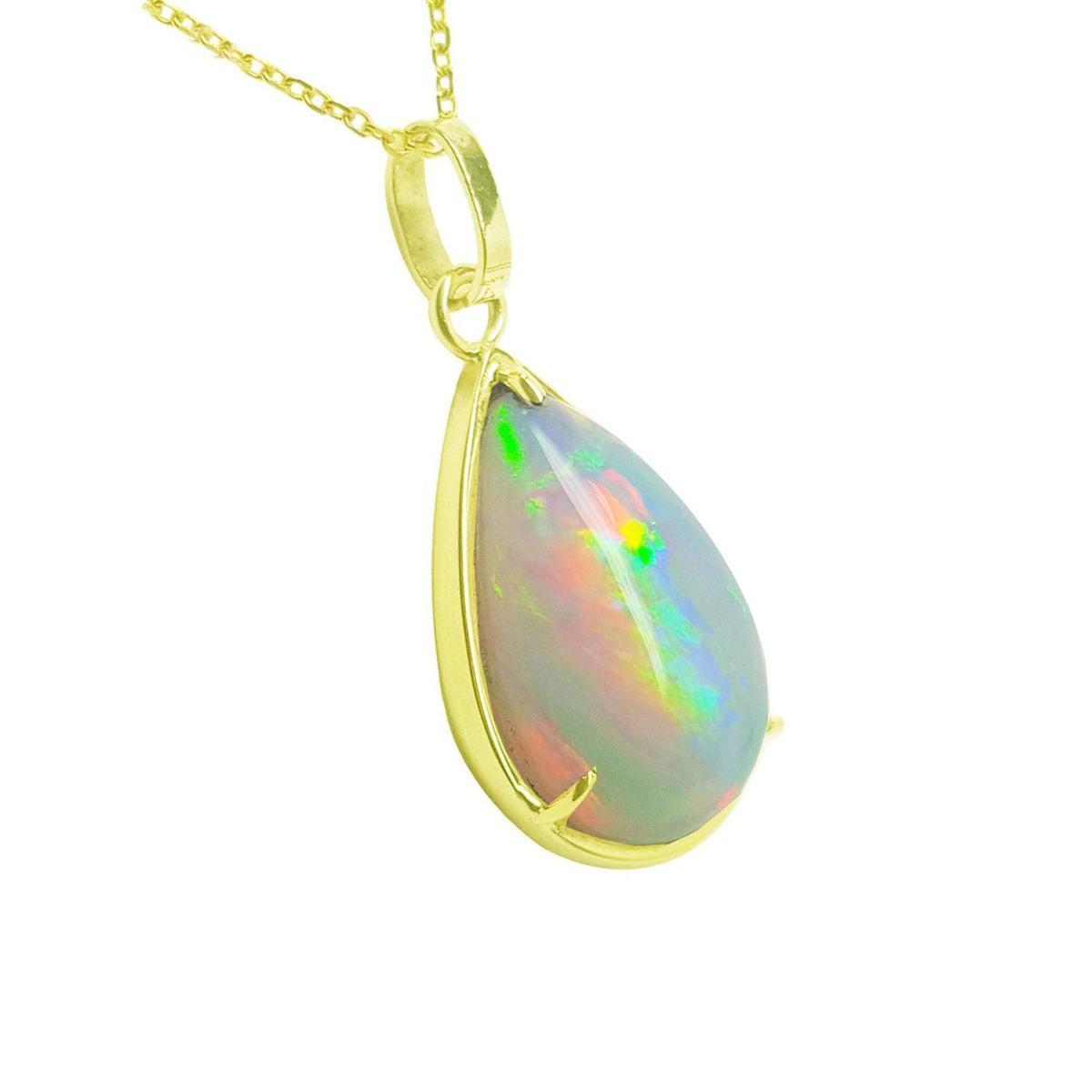 Opal pendant necklace with gold chain on a right-side profile view.