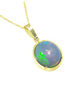 Ethiopian Welo opal pendant with gold frame on a right-side profile.